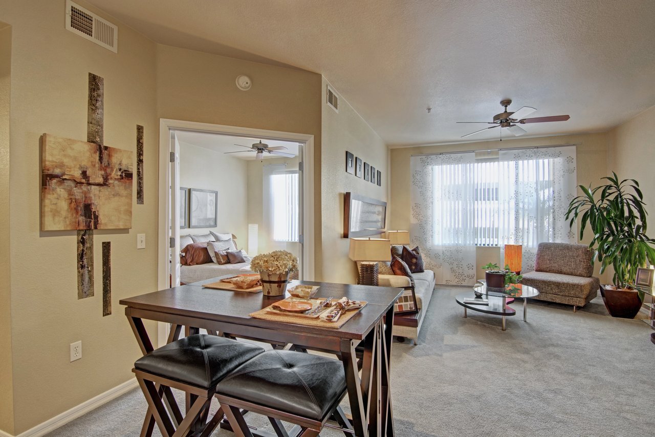 Dining area and living room with view into bedroom