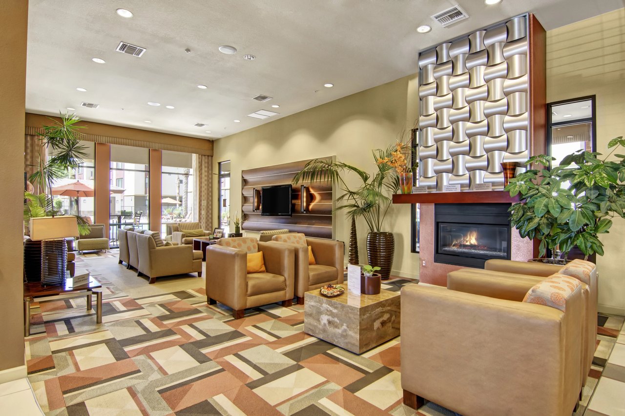 Lobby seating area with fireplace and large windows