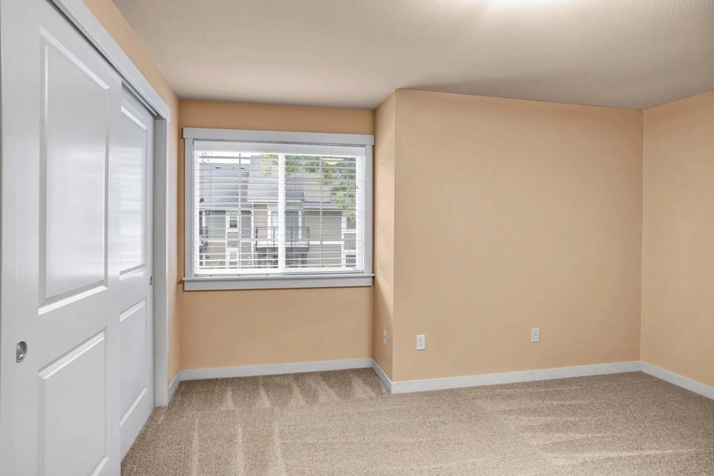 Bedroom with closet and window.
