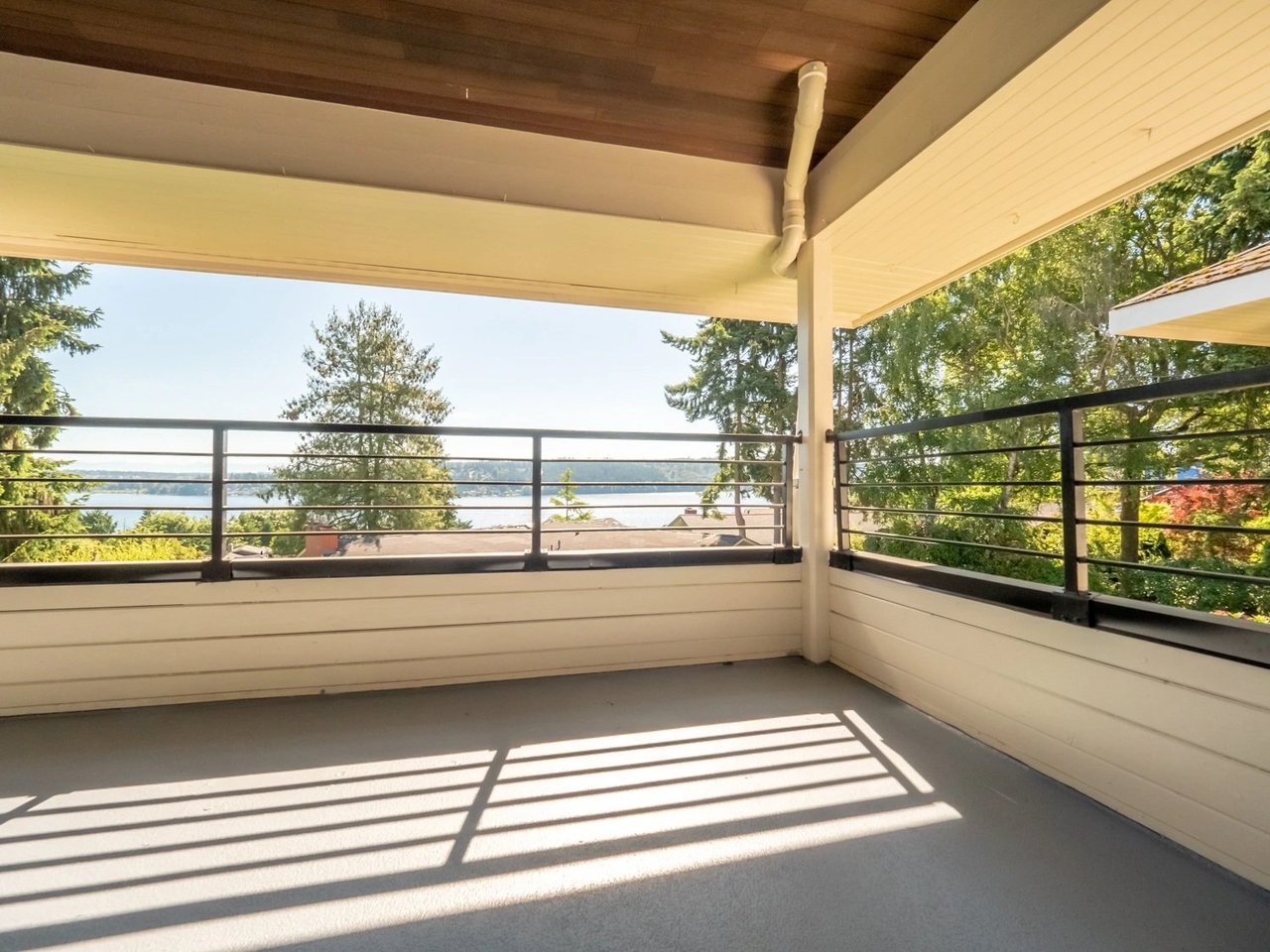 Balcony with a view of a lake and trees