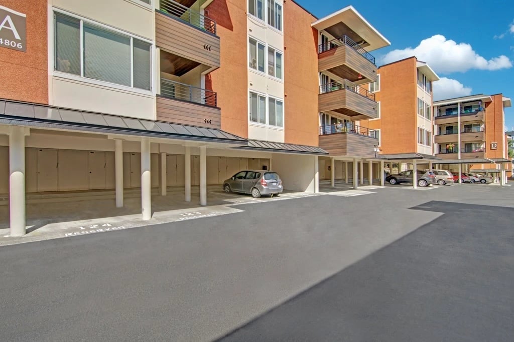 Covered parking and building exterior with balconies.