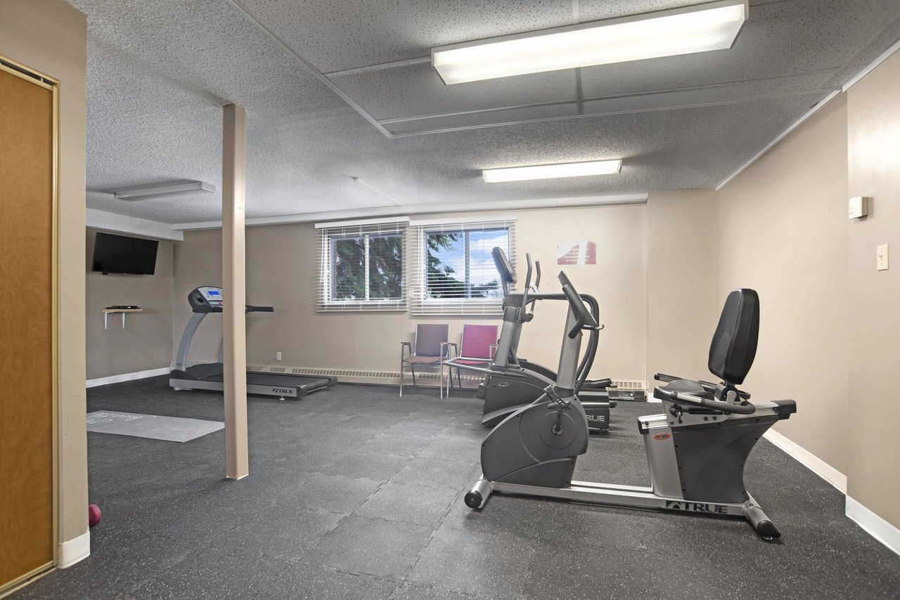 Fitness center with treadmills, elliptical, and recumbent bikes.