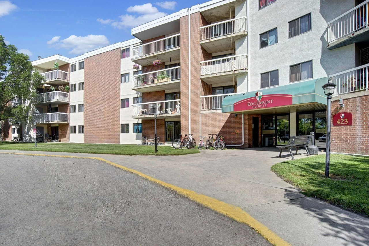 Edgemont Heights apartment building entrance and exterior with balconies and bicycles.