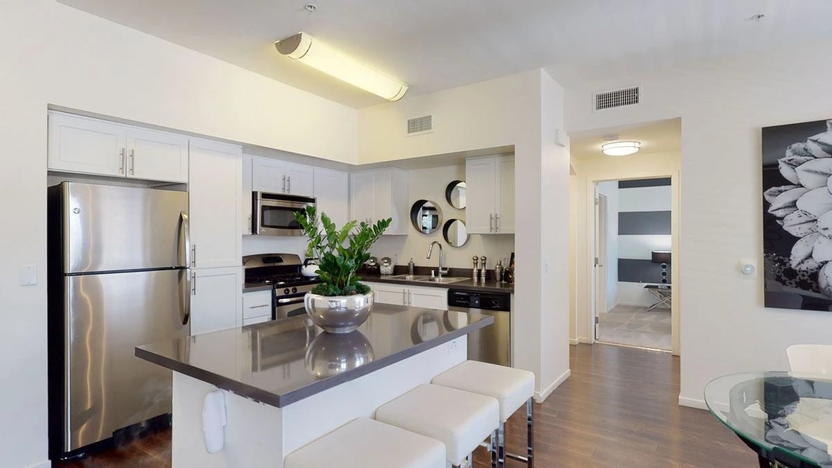 Modern kitchen with stainless steel appliances and island seating
