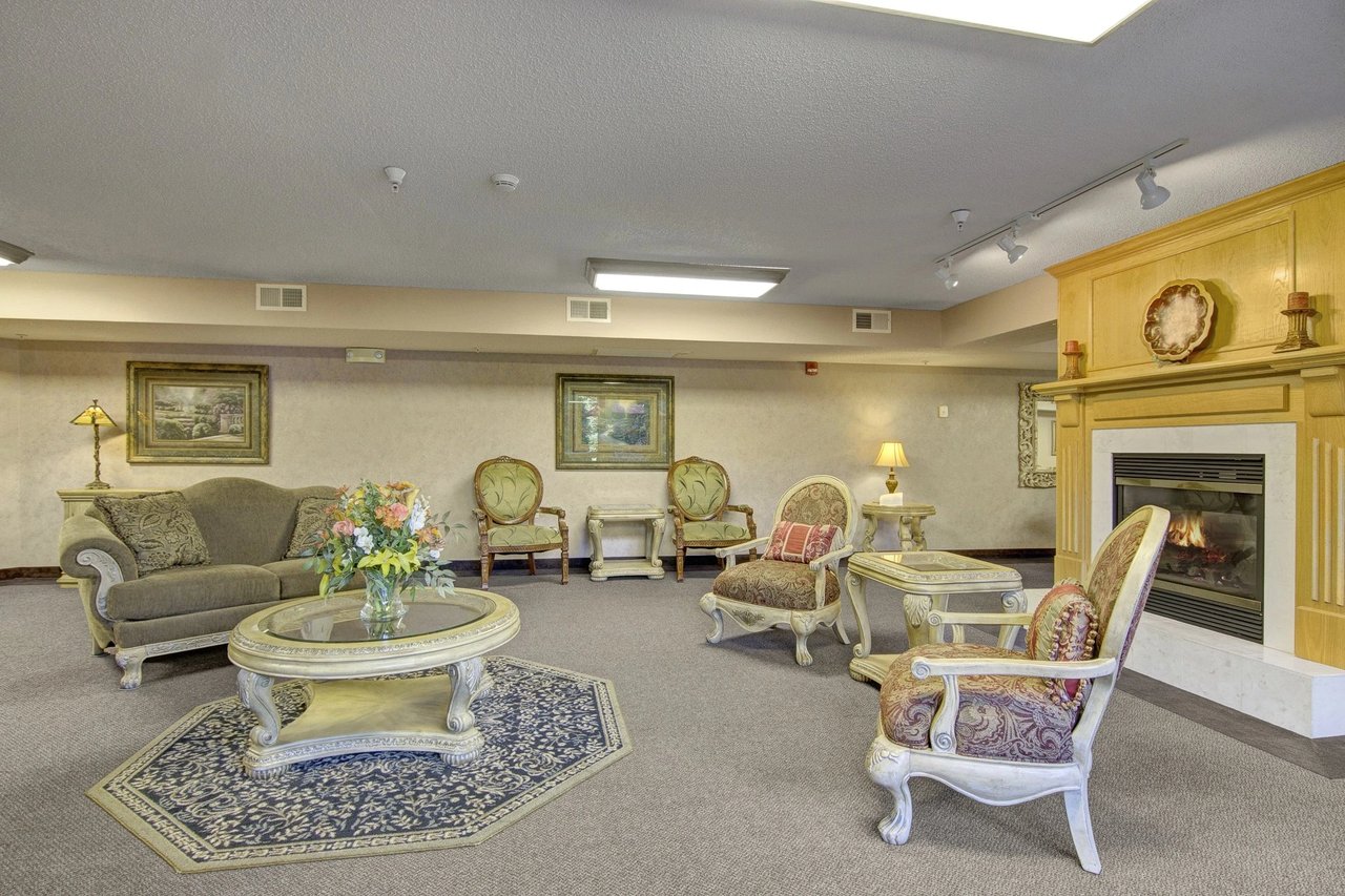 Lobby with fireplace, seating area, and decorative elements.