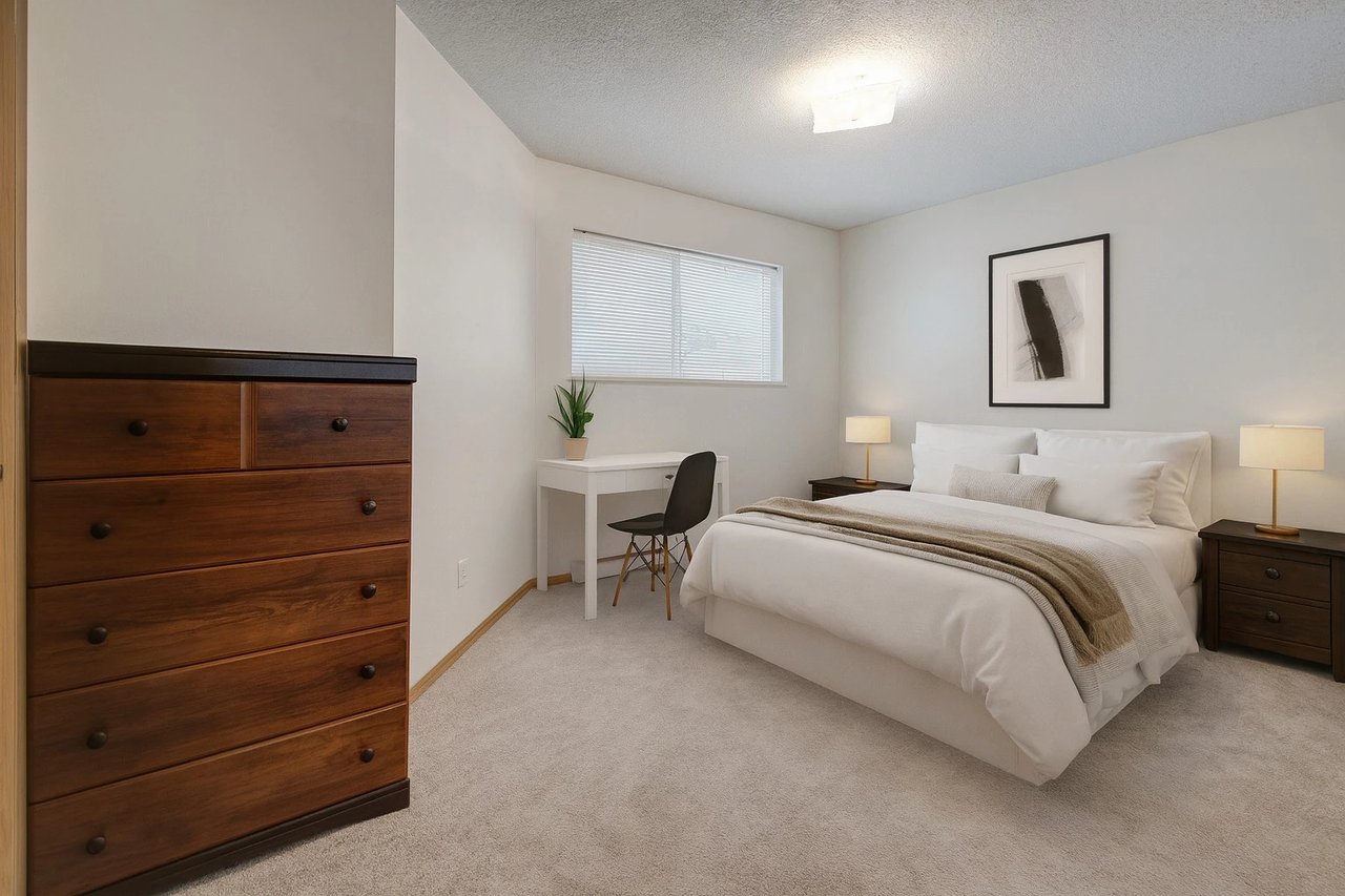 Bedroom with a bed, dresser, and desk.