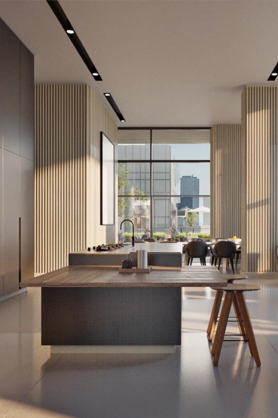 Modern kitchen island with a wooden countertop and pendant lights above.