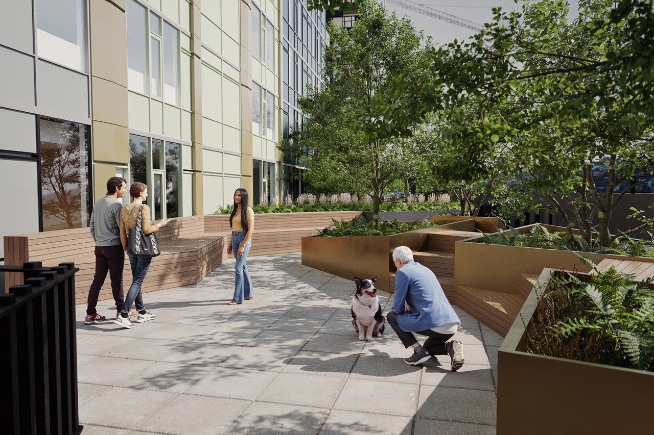 People and a dog enjoying a modern outdoor lounge area with lush greenery.