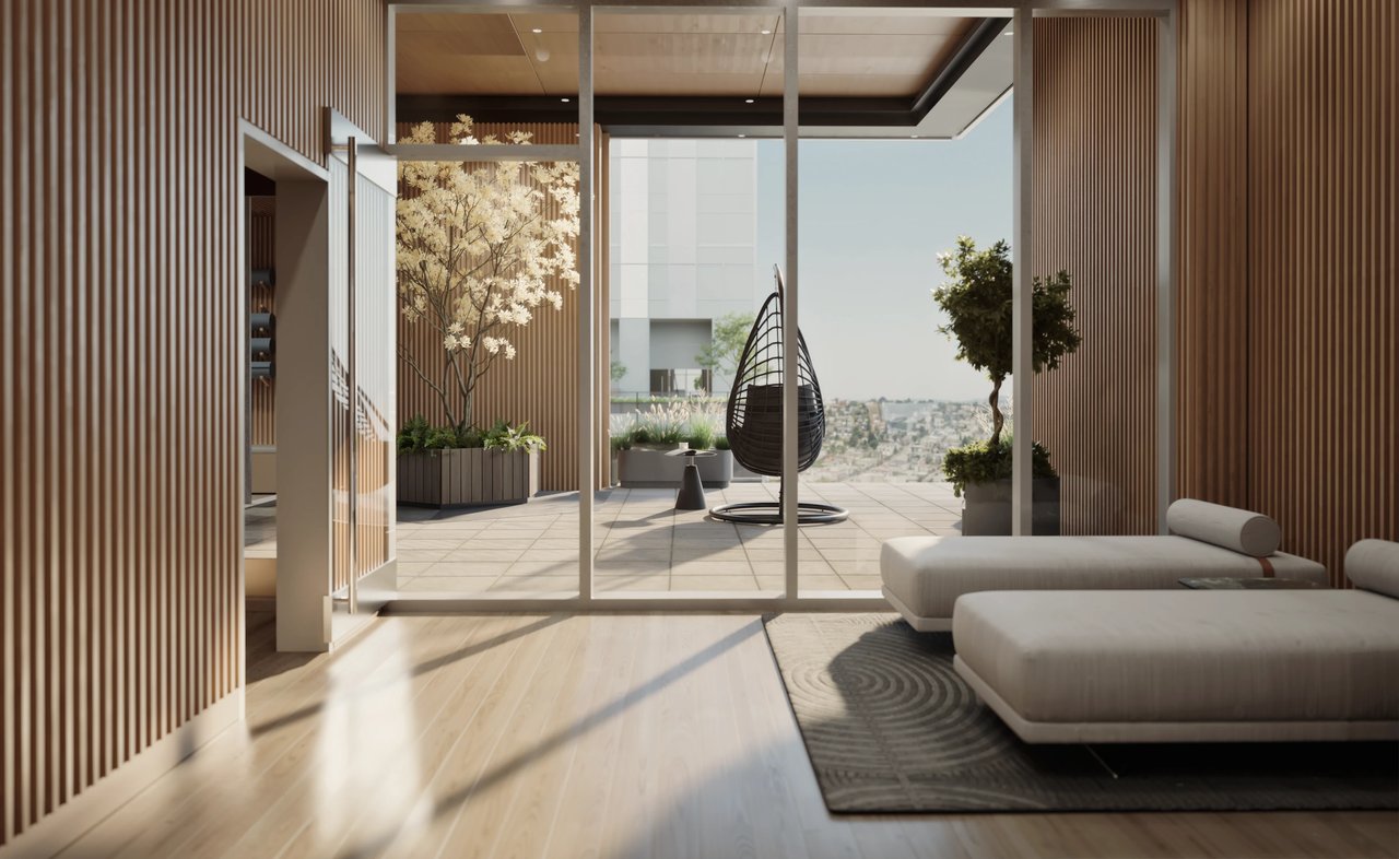 Modern lounge area with hanging chair and chaises overlooking a city view.