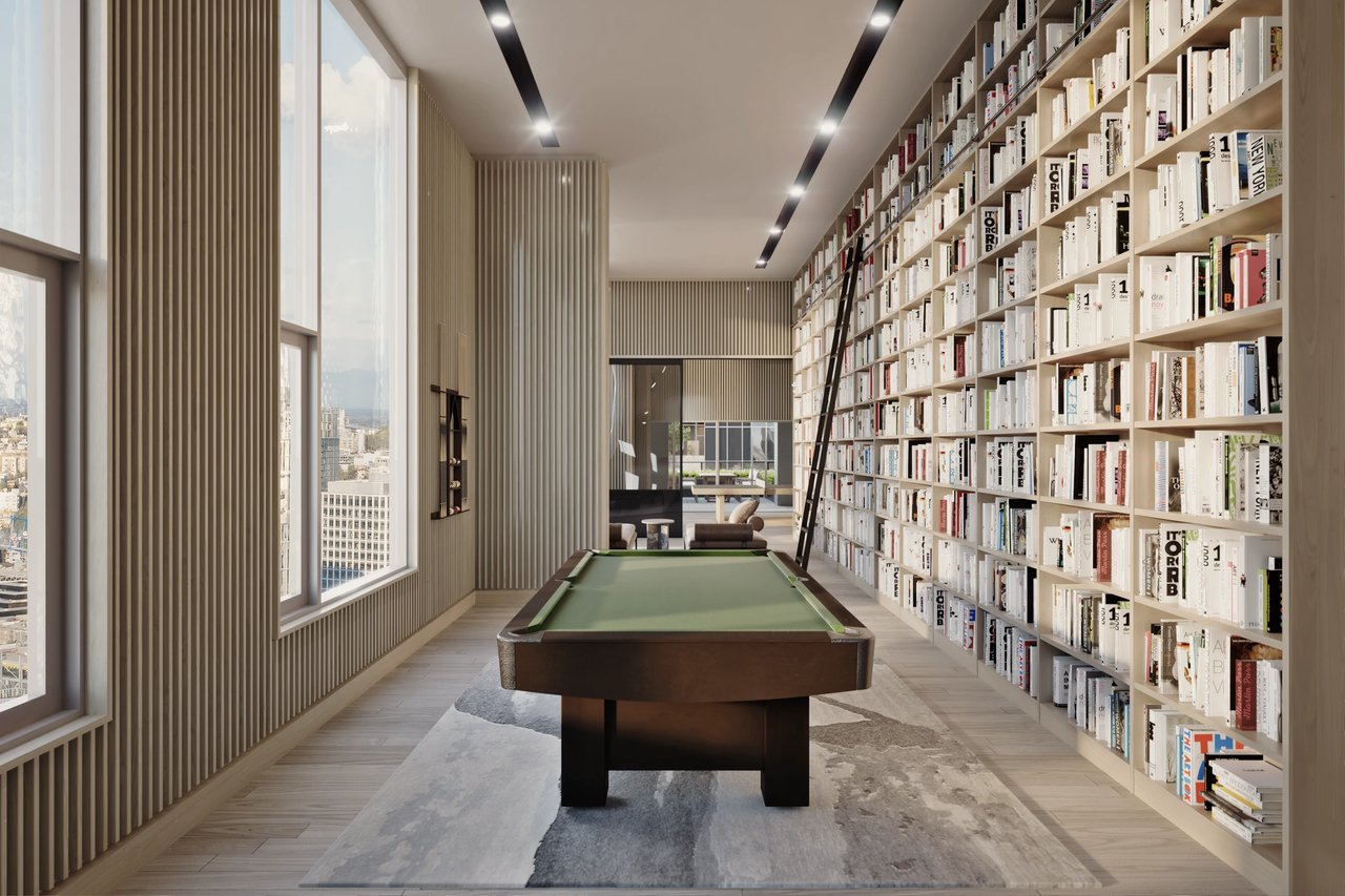 Billiards table in a library lounge with large windows and city views.