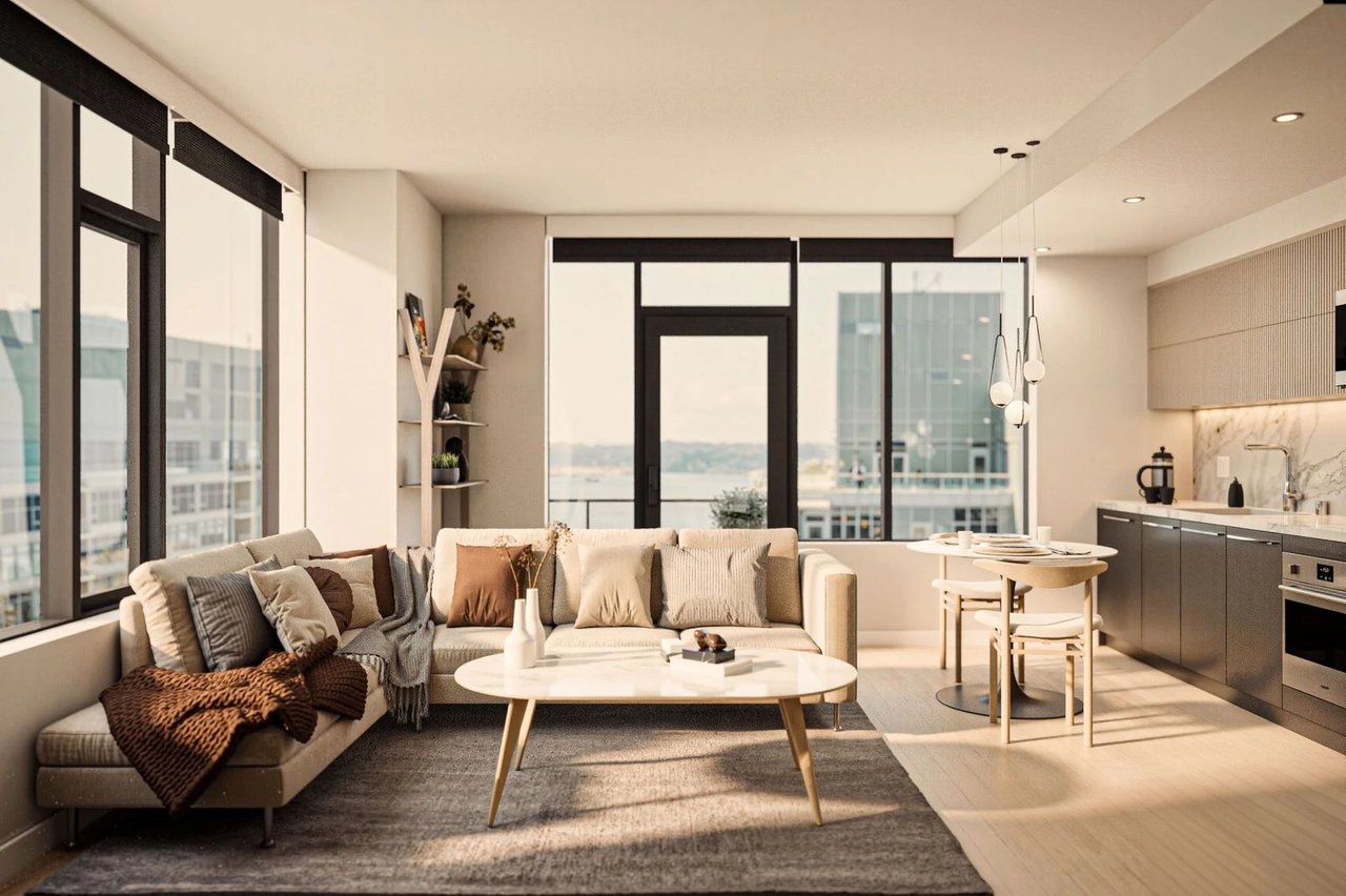 Modern living room and kitchen area in apartment with large windows and city views.