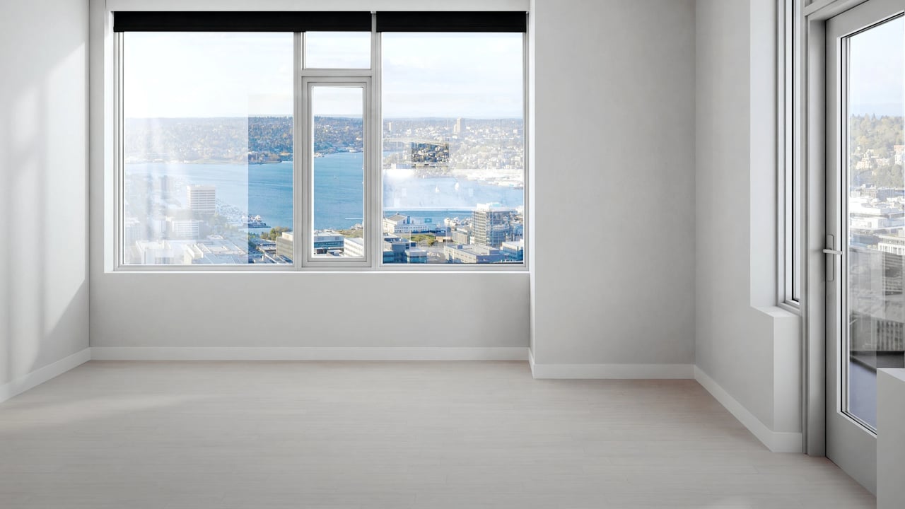 Empty room with large windows and city view