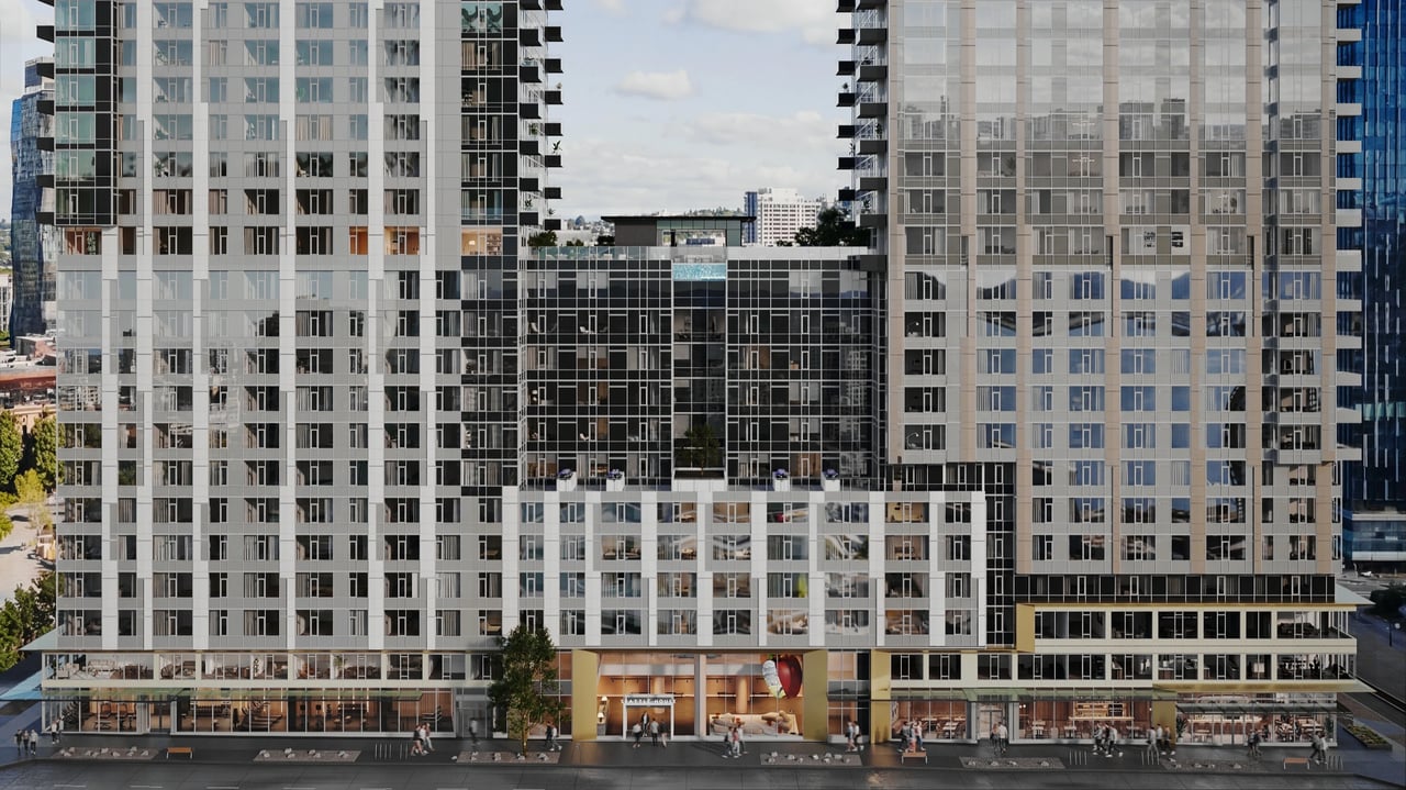 Exterior view of a modern apartment building with large windows and a rooftop pool.