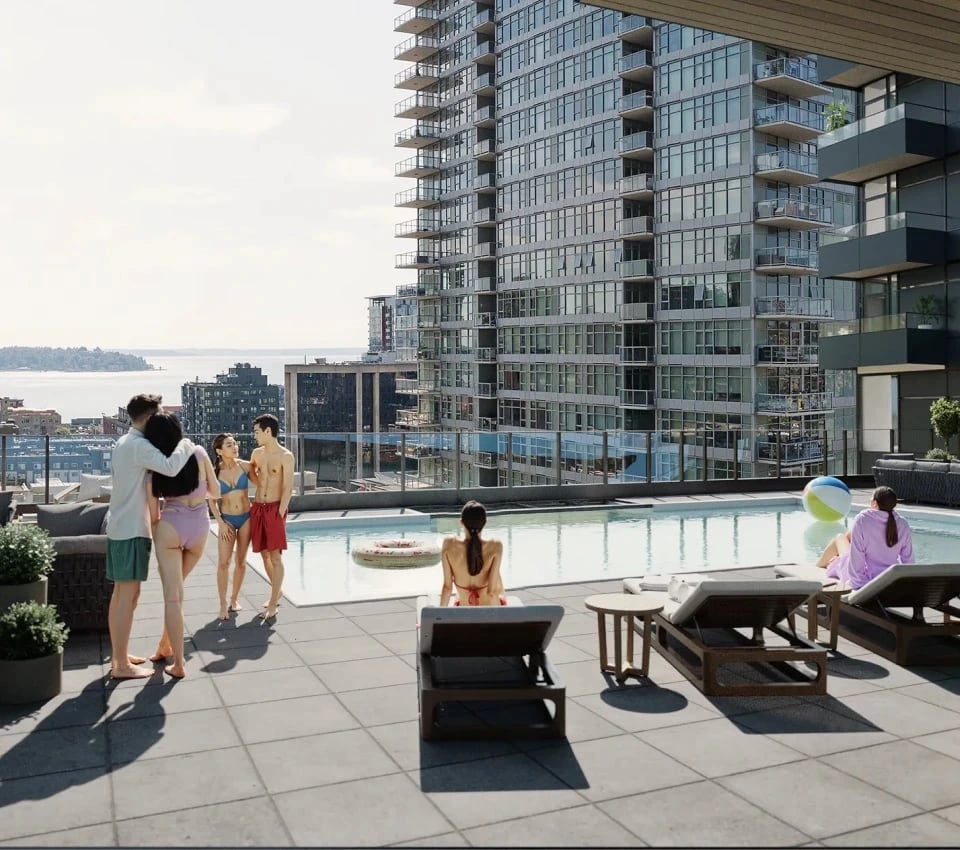 People enjoying a rooftop pool with a city view.