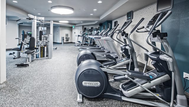Fitness center with treadmills, ellipticals, and weight machines