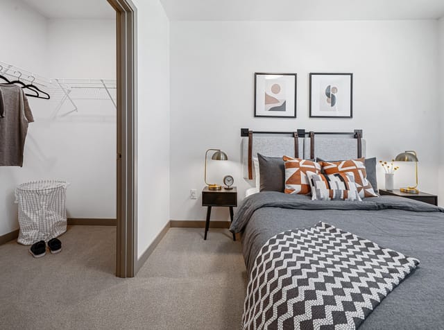 Bedroom with a large bed, nightstands, and a walk-in closet.