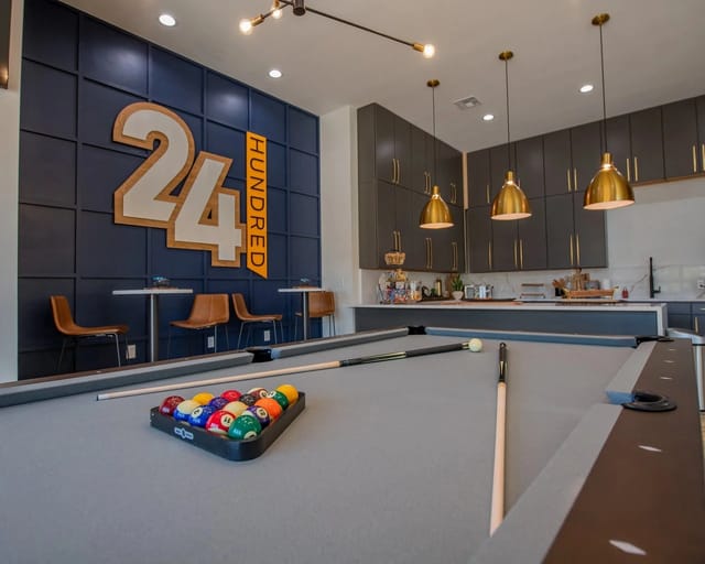 Billiard table and lounge area with seating and the property's branding.