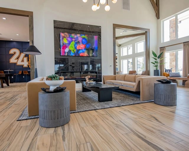 Modern lounge area with sleek sofas and a large fireplace with a colorful screen.