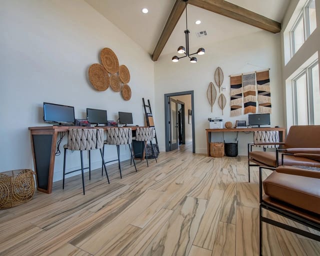 Business center with computers, printers, and seating areas.