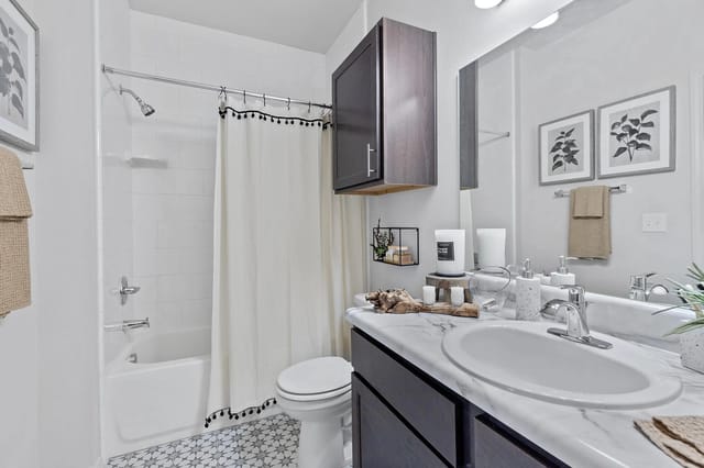 Modern bathroom featuring a bathtub, vanity, and decorative elements.