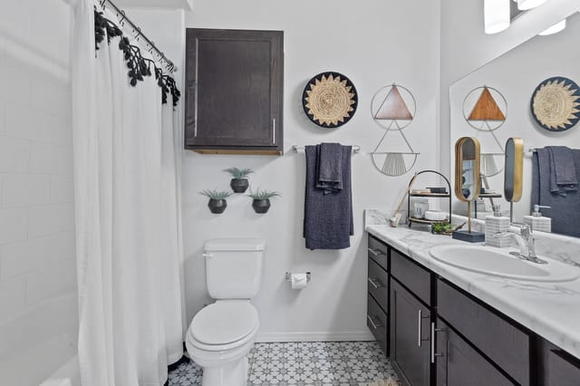 Modern bathroom with a bathtub, toilet, and stylish decor.