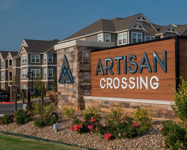 Artisan Crossing apartment complex monument sign and exterior buildings.