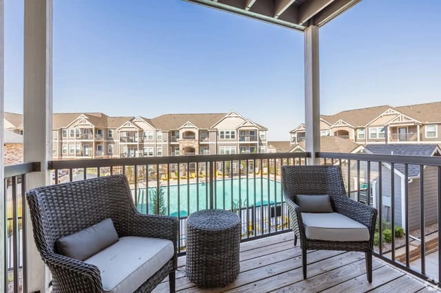 Balcony overlooking pool and apartment buildings