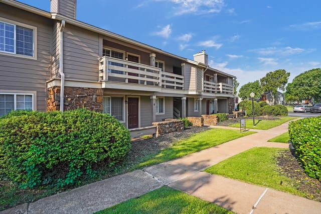 Exterior view of apartment buildings with balconies and walkways.