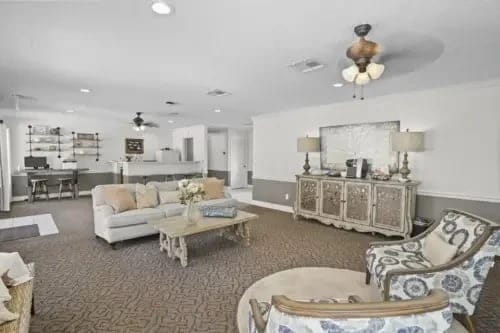 Common area lounge with comfortable seating, coffee station, and work desk.