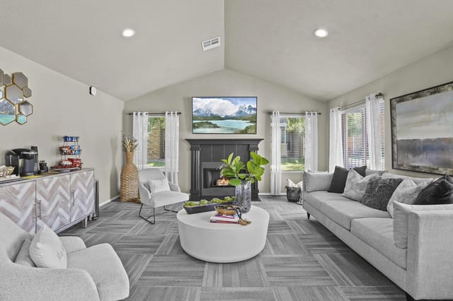 Comfortable lounge area with a fireplace, seating, and coffee bar.