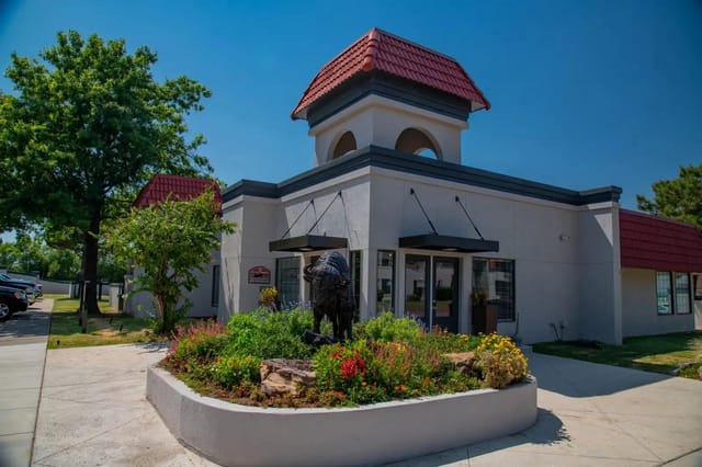 Property office building with landscaping and statue