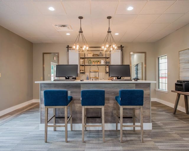 Business center with computers and seating.