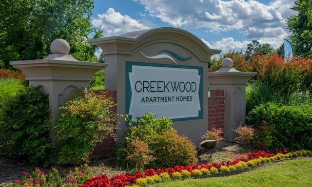 Creekwood Apartment Homes monument sign with landscaping.