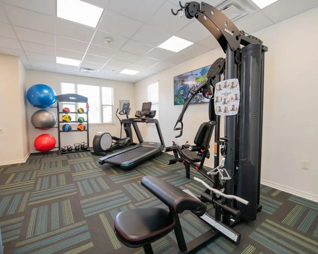 On-site fitness center with treadmills, weight machine, and exercise balls.