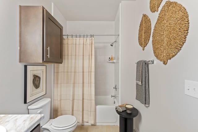 Modern bathroom with toilet, shower, and vanity
