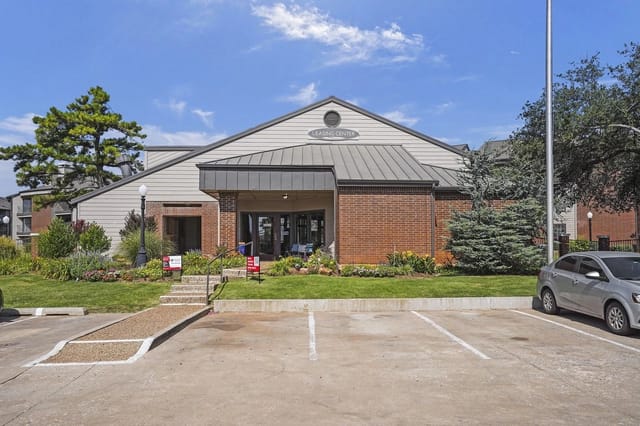 Exterior of the leasing center with parking lot in foreground.