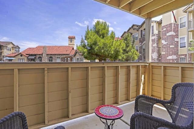 Balcony view overlooking the community's resort-style pool and buildings.