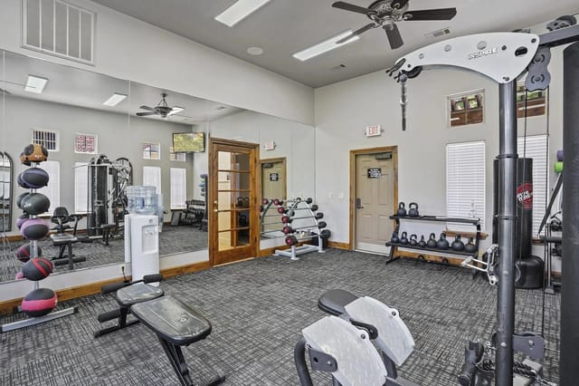 Well-equipped fitness center with free weights, cardio machines, and weight machines.