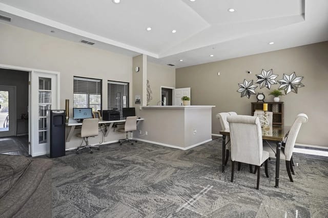 Business center with computers, printers, and a water cooler.