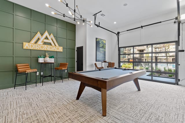 Lobby with pool table and Adirondack logo.