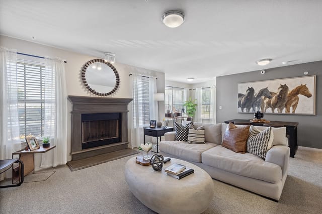 Spacious living room with a fireplace, large sofa, and coffee table.