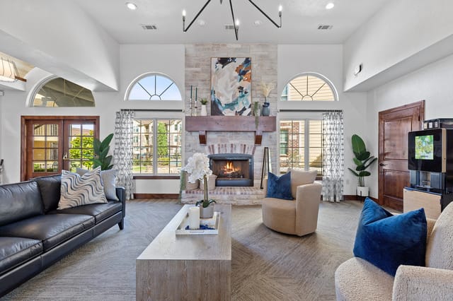 Cozy community lounge area with a fireplace and seating.