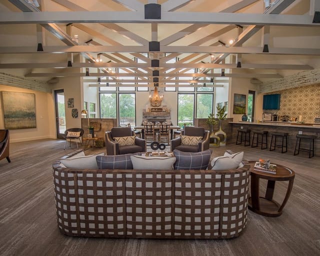 Spacious community lounge with contemporary seating, a fireplace, and a bar area.