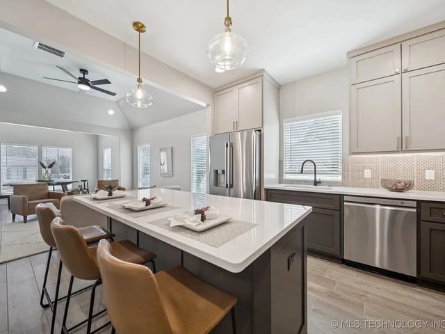 Modern kitchen with bar seating and stainless steel appliances