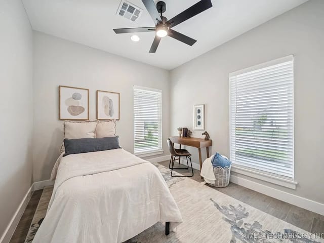 Cozy bedroom with a single bed, desk, and decor.