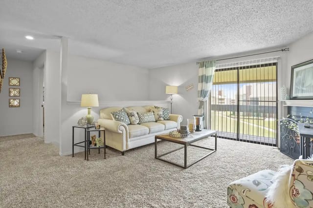 Cozy living room featuring a beige sofa and decorative table.