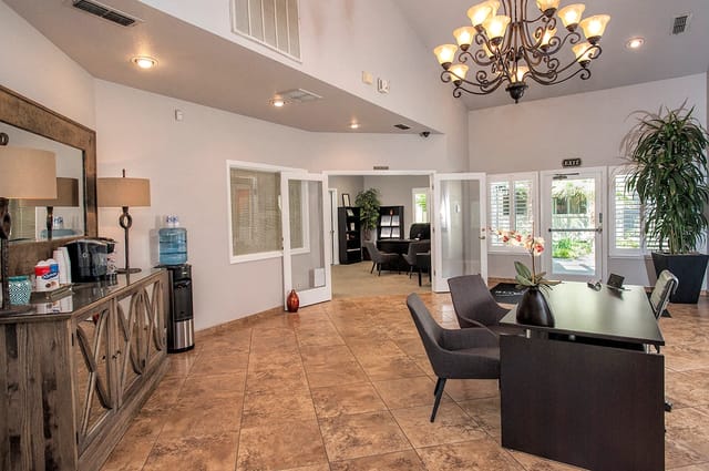 Property management office reception area with coffee station and seating.