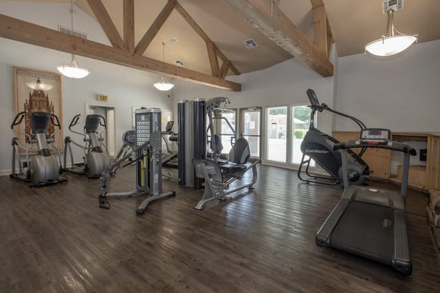 Gym with cardio machines and weight training equipment.