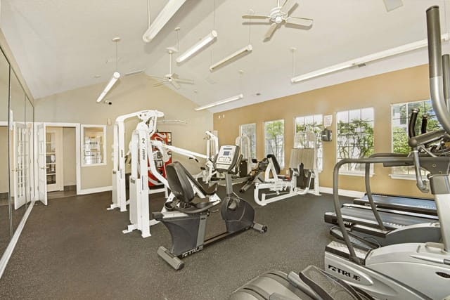 Fitness center with cardio machines and weight training equipment.