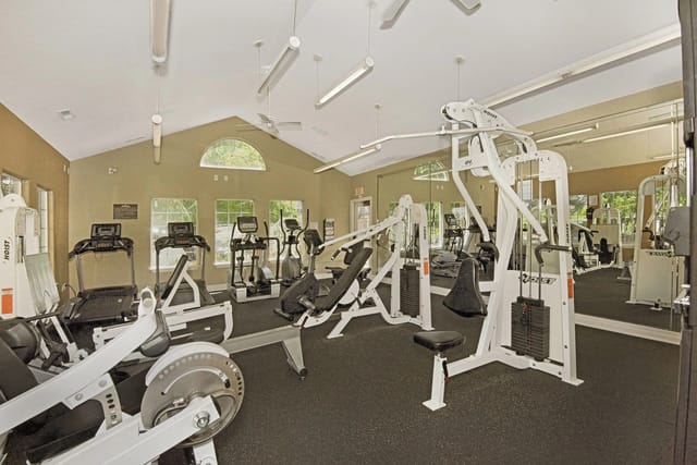Fitness center with cardio machines and weight training equipment.